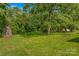 Expansive backyard featuring lush greenery and mature trees, perfect for outdoor enjoyment at 157 E Meadowview Dr, Statesville, NC 28625