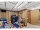 Cluttered basement with wood paneling, treadmill, chair, and assorted storage items at 157 E Meadowview Dr, Statesville, NC 28625