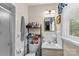Clean bathroom features a shower, white tile and updated fixtures at 157 E Meadowview Dr, Statesville, NC 28625
