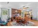 Cozy dining room featuring a brick fireplace, a wooden dining set, and hardwood floors at 157 E Meadowview Dr, Statesville, NC 28625