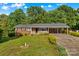 Charming single-story brick home with a welcoming front porch and a well-maintained, expansive front lawn at 157 E Meadowview Dr, Statesville, NC 28625