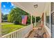 Covered front porch with seating, American flag, and a view of the neighborhood at 157 E Meadowview Dr, Statesville, NC 28625