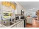 Charming kitchen with stainless steel sink, black appliances and views to dining room at 157 E Meadowview Dr, Statesville, NC 28625