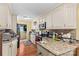 Cozy kitchen features granite countertops, custom cabinets, and black appliances at 157 E Meadowview Dr, Statesville, NC 28625