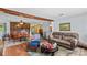 Inviting open-concept living room and dining area with hardwood floors and brick fireplace at 157 E Meadowview Dr, Statesville, NC 28625