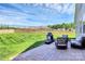 Expansive back patio has a stone fireplace, outdoor seating, and a lush, well-maintained lawn at 174 Hanks Bluff Dr, Mooresville, NC 28117