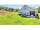 Spacious backyard with a stone patio, comfortable seating, and manicured landscaping at 174 Hanks Bluff Dr, Mooresville, NC 28117