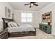 Comfortable bedroom features a ceiling fan, large window, and stylish furnishings at 174 Hanks Bluff Dr, Mooresville, NC 28117