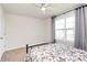 Bright bedroom featuring a large window, ceiling fan, carpet and decorative bedding at 174 Hanks Bluff Dr, Mooresville, NC 28117