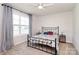 Bright bedroom featuring a large window, ceiling fan, carpet and decorative bedding at 174 Hanks Bluff Dr, Mooresville, NC 28117