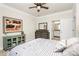 Well-lit bedroom with a ceiling fan, dresser, and view into the bathroom, designed for comfort at 174 Hanks Bluff Dr, Mooresville, NC 28117