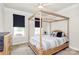 Bedroom featuring a canopy bed with blue and white bedding, and natural light from two windows at 174 Hanks Bluff Dr, Mooresville, NC 28117