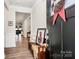 Welcoming foyer with a bench, complemented by hardwood floors and a charming view into the living room at 174 Hanks Bluff Dr, Mooresville, NC 28117