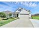 Beautiful home with a well-maintained lawn, a covered porch, and a two-car garage at 174 Hanks Bluff Dr, Mooresville, NC 28117