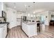 Open-concept kitchen with granite countertops, stainless steel appliances, and an island at 174 Hanks Bluff Dr, Mooresville, NC 28117