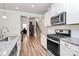 Updated kitchen with stainless steel appliances, granite countertops, and hardwood floors at 174 Hanks Bluff Dr, Mooresville, NC 28117