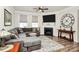 Cozy living room featuring a fireplace, large TV, comfortable seating, and stylish decor for relaxation at 174 Hanks Bluff Dr, Mooresville, NC 28117
