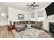 Spacious living room with a plush sectional sofa, fireplace, and large windows for natural light at 174 Hanks Bluff Dr, Mooresville, NC 28117