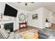 Comfortable living room features a fireplace, large clock, and views into other areas of the home at 174 Hanks Bluff Dr, Mooresville, NC 28117