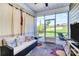 Inviting screened porch features comfortable seating and views of the landscaped backyard at 174 Hanks Bluff Dr, Mooresville, NC 28117