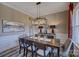 Elegant dining room with modern chandelier, decorative art and an ample dining table at 18125 Sulton Terrace Dr, Huntersville, NC 28078