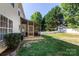 Spacious backyard featuring a screened-in porch, well-maintained lawn, and privacy fence, perfect for outdoor enjoyment at 18629 Coachmans Trce, Cornelius, NC 28031