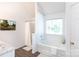 Bright bathroom featuring a soaking tub, shower, and modern fixtures at 18629 Coachmans Trce, Cornelius, NC 28031