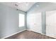 Bedroom featuring hardwood floors, patterned wallpaper, and ample closet space at 18629 Coachmans Trce, Cornelius, NC 28031