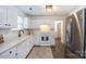 Modern kitchen with white cabinets, countertops and stainless steel appliances at 18629 Coachmans Trce, Cornelius, NC 28031