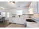 Bright, modern kitchen features white cabinets, and a view to the rear patio door at 18629 Coachmans Trce, Cornelius, NC 28031