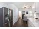 Bright eat-in kitchen with stainless steel refrigerator and room for a small table at 18629 Coachmans Trce, Cornelius, NC 28031