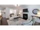 Bright living room featuring a cozy fireplace, plush seating, and stylish decor at 18629 Coachmans Trce, Cornelius, NC 28031