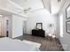 Main bedroom featuring a tray ceiling, neutral decor, and hardwood floors at 18629 Coachmans Trce, Cornelius, NC 28031