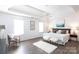 Main bedroom showcasing a tray ceiling, ceiling fan and two windows at 18629 Coachmans Trce, Cornelius, NC 28031