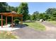 Community park featuring covered picnic area, playground, and walking path, perfect for Gathering enjoyment at 18629 Coachmans Trce, Cornelius, NC 28031