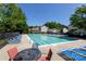 Sparkling community pool with lounge chairs and tables providing a relaxing outdoor space for residents at 18629 Coachmans Trce, Cornelius, NC 28031