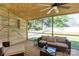 Comfortable screened-in porch perfect for outdoor relaxation and entertaining, with wicker furniture and wooded views at 18629 Coachmans Trce, Cornelius, NC 28031