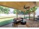 Relaxing screened porch overlooking a lush backyard, complete with outdoor furniture for serene living at 18629 Coachmans Trce, Cornelius, NC 28031