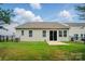 A well-maintained backyard featuring a grassy lawn and a sliding glass door entrance at 1957 Tablerock Dr # 59, York, SC 29745