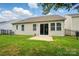 Inviting backyard featuring a small patio, lush lawn, and secure black fencing, great for outdoor activities at 1957 Tablerock Dr # 59, York, SC 29745