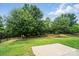Lush backyard with mature trees, a patio, and secure black fencing, creating a private and serene outdoor space at 1957 Tablerock Dr # 59, York, SC 29745