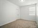A bright bedroom with neutral carpet, complemented by natural light from a window at 1957 Tablerock Dr # 59, York, SC 29745