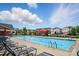 Community pool with lounge chairs, umbrella tables, and seating at 1957 Tablerock Dr # 59, York, SC 29745