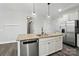 Kitchen island featuring granite countertops, a sink, and stainless steel dishwasher, offering a central workspace at 1957 Tablerock Dr # 59, York, SC 29745