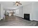 Bright living room with fireplace and views of the open-concept kitchen featuring a large island and white cabinets at 1957 Tablerock Dr # 59, York, SC 29745
