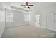 Bright main bedroom with tray ceiling, neutral carpet, and ensuite bathroom at 1957 Tablerock Dr # 59, York, SC 29745