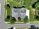 An aerial view shows a brick home with mature landscaping and tree coverage in a residential neighborhood at 201 Vanderbilt Blvd, Locust, NC 28097