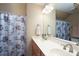 A clean bathroom featuring double sinks, coordinated decor and a patterned shower curtain at 201 Vanderbilt Blvd, Locust, NC 28097