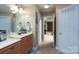 This functional bathroom showcases a vanity with storage and a glimpse of a carpeted bedroom at 201 Vanderbilt Blvd, Locust, NC 28097
