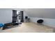 A carpeted bonus room features a treadmill, workspace, and window to provide ample sunlight at 201 Vanderbilt Blvd, Locust, NC 28097